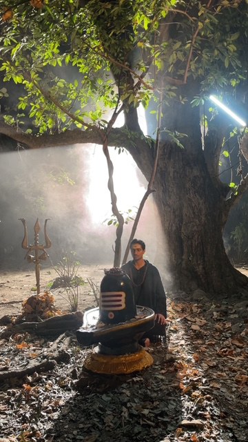 Saheb beside a Shivling beneath a sacred tree